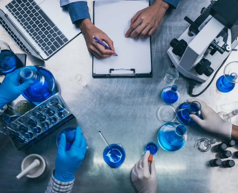 top-view-workspace-laboratory-with-microscope-laptop-laboratory-tools-min-800x650
